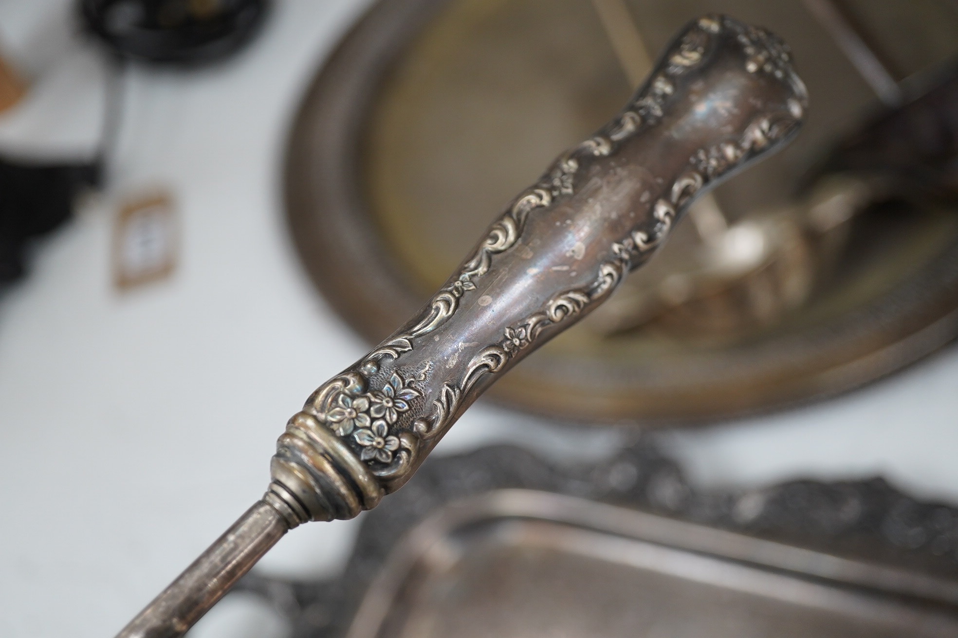 A collection of silver plate comprising large punchbowl, three plated ladles and three plated trays, punchbowl 43cm diameter. Condition - fair, worn